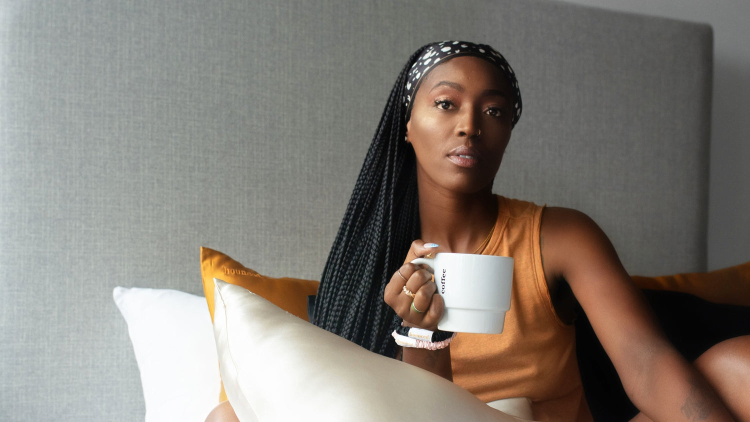 Girl in bed drinking coffee with Bounced pillows and edge scarf